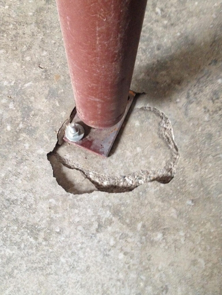 Floor deflection at post. This is why an engineer needs to inspect the slab to ensure it is strong enough to take the weight of the post or column. If not, a footing needs to be installed