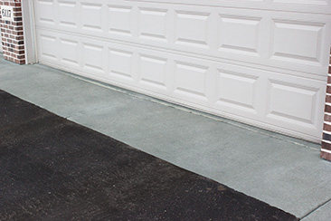 A concrete garage apron extending 3 feet outside of a garage door