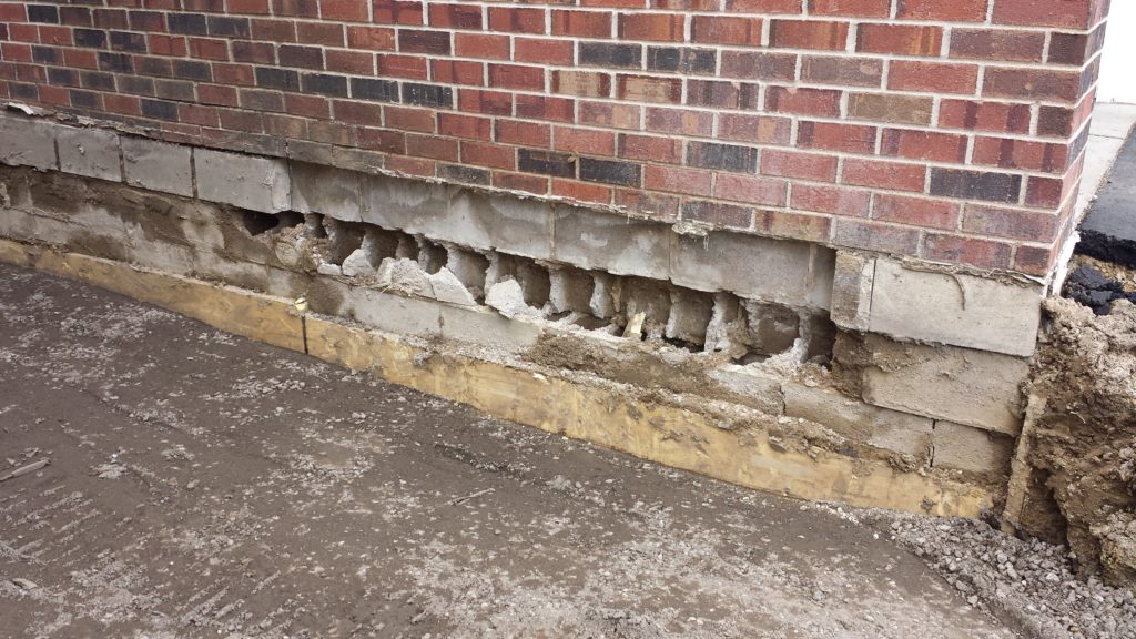 Deteriorating foundation from poor soils holding water against the foundation 

