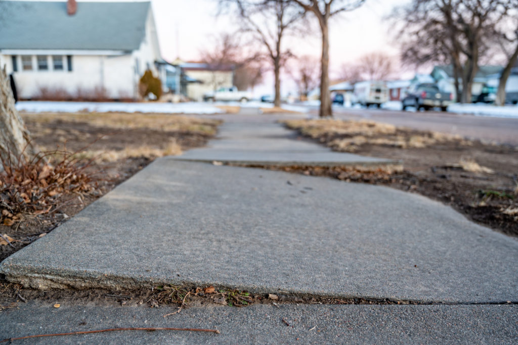 Uneven sidewalk from frost heave.