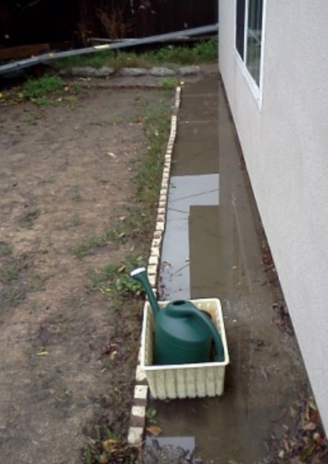 Plant border drawing water to the foundation.